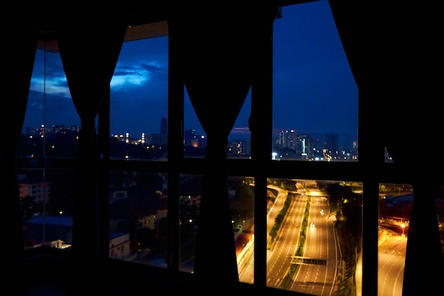 Night view from the window of the apartment on a multilane highway in the direction of the metropolis Night view