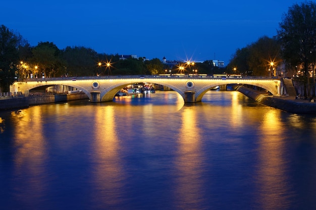 The night view of LouisPhilippe bridge across Seine river Paris France