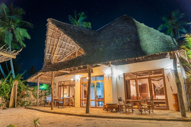 Night view of a luxury villa on the tropical beach near sea on the island of Zanzibar Tanzania Africa