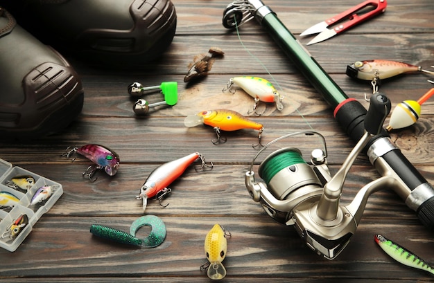 Nikolaev Ukraine 08 july 2022 Fishing rods and spinnings in the composition with accessories for fishing on brown background