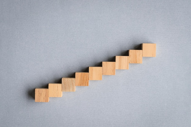 Nine wood cubes arranged as step stair going up