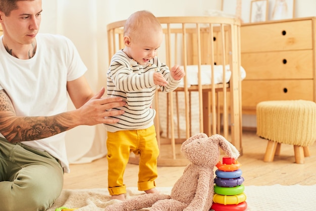 Ninemonthold baby plays with dad in the children's room