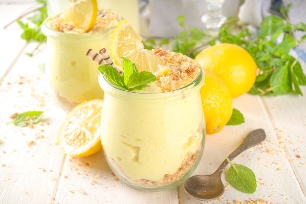 No baked homemade lemon cheesecake with mint in small vintage jars