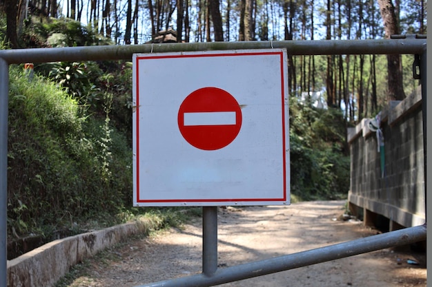 Photo no entry sign on the gate the road is closed with a red round sign