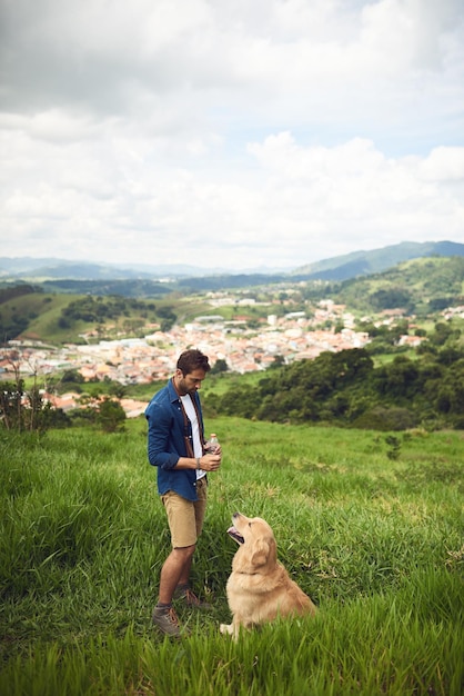 No leash required Full length shot of a handsome young man taking his dog for a walk in the mountains