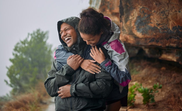 No one could ever make me feel the way you do Shot of a young couple wearing their rain jackets while out hiking