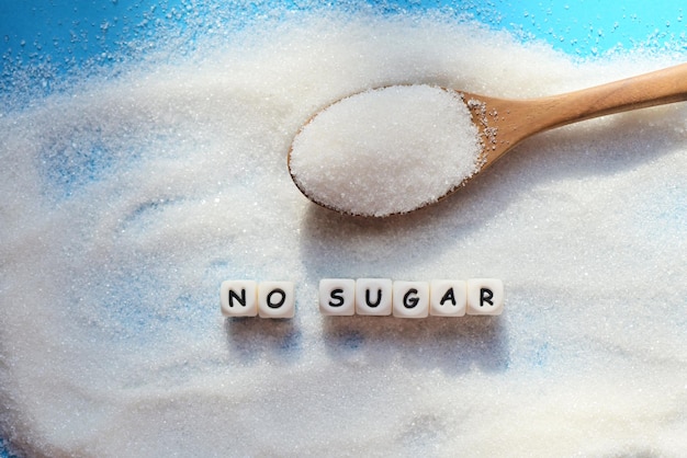 No sugar concept Sugar on spoon and blur background white sugar for food and sweets dessert candy heap of sweet sugar crystalline granulated