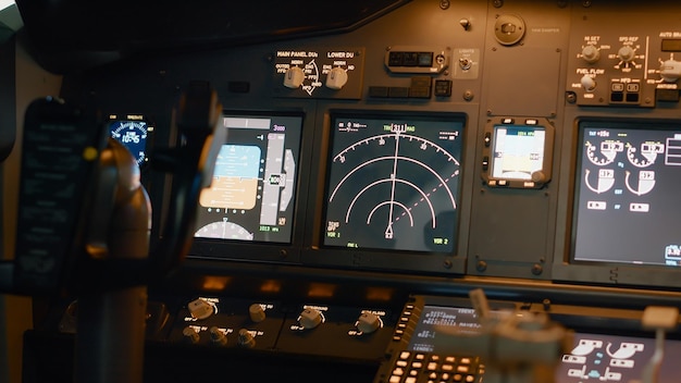 Nobody in plane cabin with control panel and navigation compass, dashboard with power buttons to fly airplane. Airplane cockpit with switch, windscreen and engine handle. Close up.