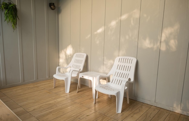 Nobody white chair around outdoor swimming pool in resort hotel empty