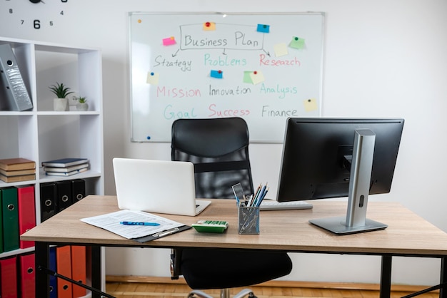 Nobody workplace with laptop financial documents pen calculator at office interior