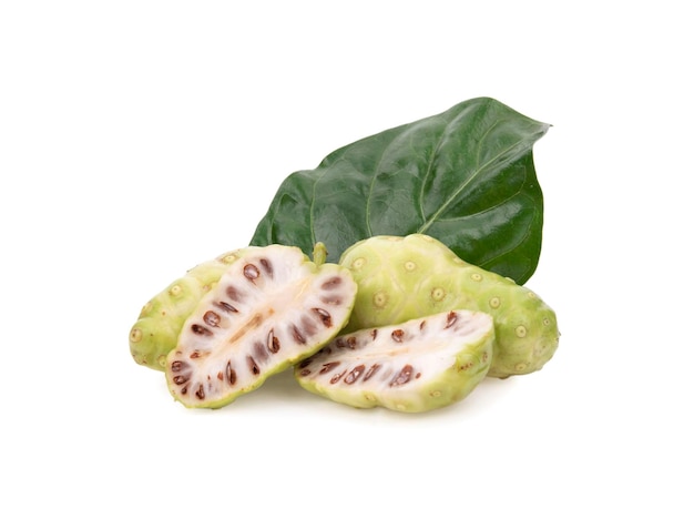 Noni or Morinda Citrifolia fruits with sliced and green leaf isolated on white background