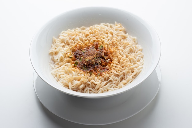 Noodle in bowl on white background top view