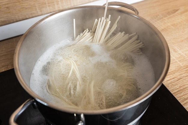 Noodles are cooked in a saucepan