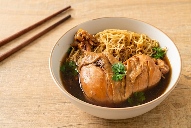 Noodles with Braised Chicken in Brown Soup Bowl - Asian food style