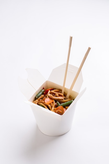 Noodles with chopsticks in box