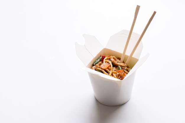 Noodles wok in cardboard box on white background