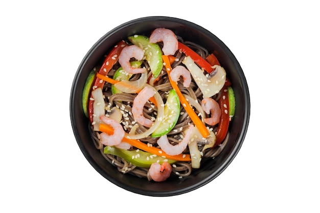 Noodles wok with vegetables herbs and sesame In a black round plate On a white background