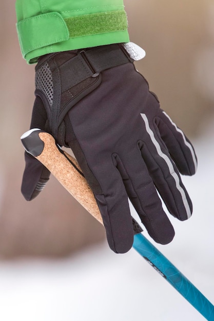 Nordic walking healthy lifestyle outdoor sports in winter a mans hand squeezes the handle of a cane