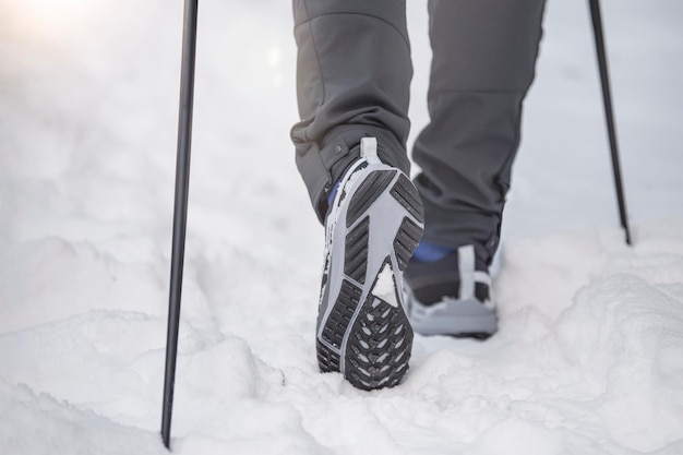 Nordic walking in winter sports activities in the winter on the snow a man is engaged in nordic walk