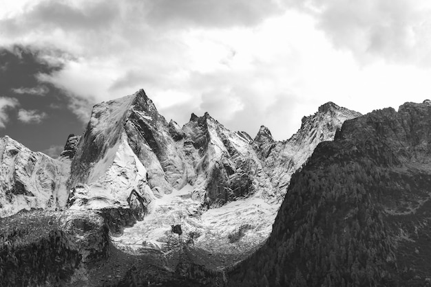 The north face of the mountain of the Rhaetian Alps in Switzerland. Pizzo Badile with the first autumn snow