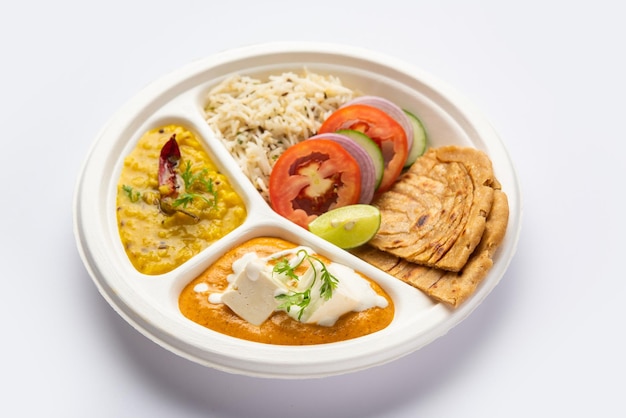 North Indian mini meal parcel platter or combo thali with paneer butter masala roti dal and rice