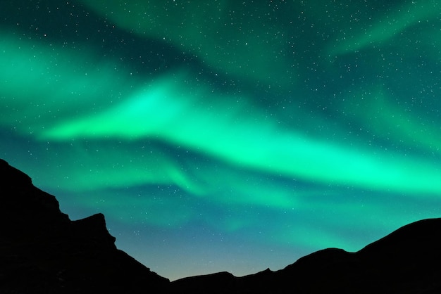 Northern lights in winter mountains