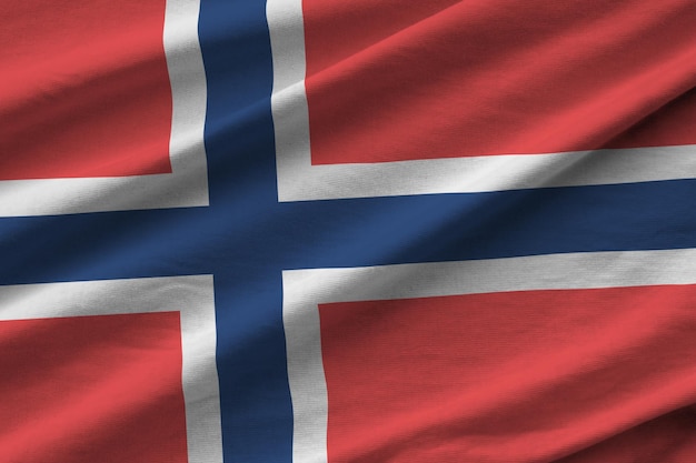 Norway flag with big folds waving close up under the studio light indoors The official symbols and colors in banner