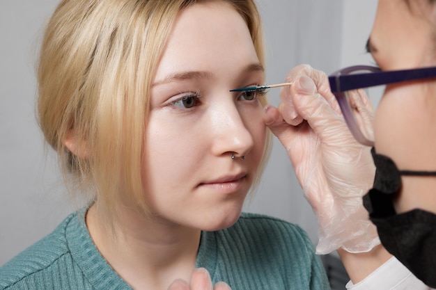 Nose Bridge Piercing Professional holding the jewel of piercing day just before screw the ball