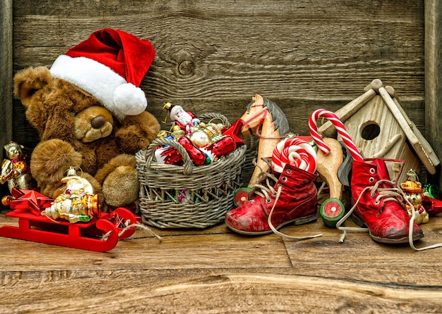 Nostalgic christmas decorations with antique toys over wooden background. retro style toned picture