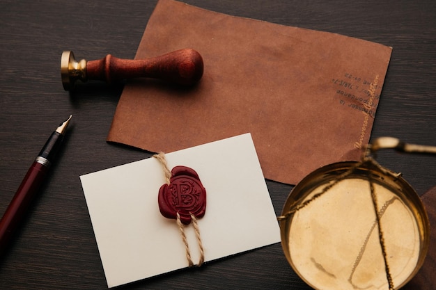 Notary stamp scale and envelope with wax seal on a wooden table Notary tools