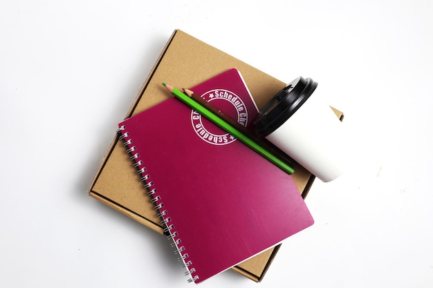 Note Book with cup and green pencil