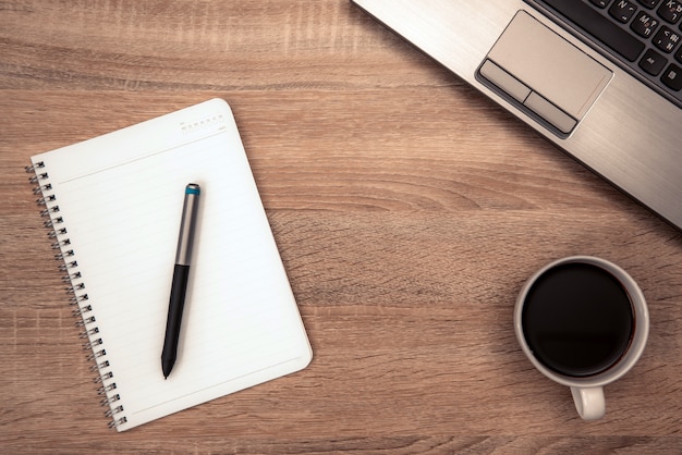 note and cup of coffee on working table