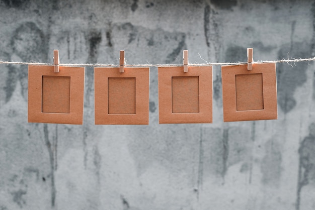 Note or picture frame on the rope and Tweezers abstract background 