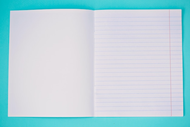 Notebook on bright light blue background