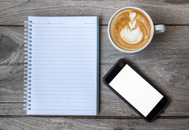 notebook coffee and smartphone on wood table