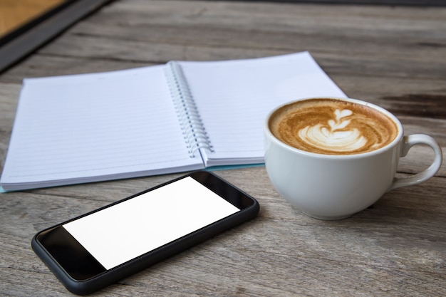 notebook coffee and smartphone on wood table