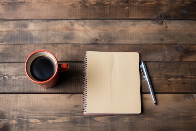 A notebook and a cup of coffee on a wooden table.