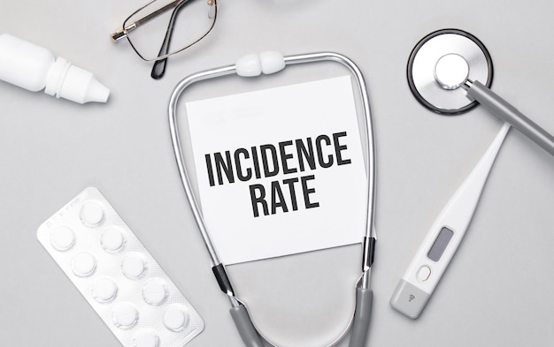 In the notebook is the text incidence rate, stethoscope, pills, and glasses