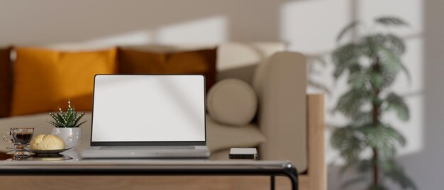 Notebook laptop and accessories on coffee table in comfortable minimal living room