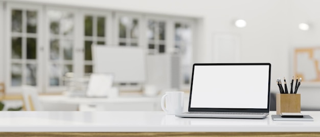 Notebook laptop mockup and copy space on tabletop over blurred bright office coworking space