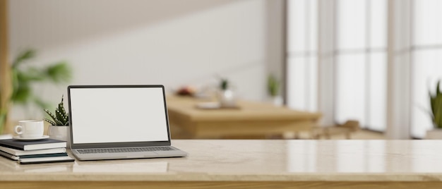 Notebook laptop mockup and copy space on tabletop over blurred minimal home dining room