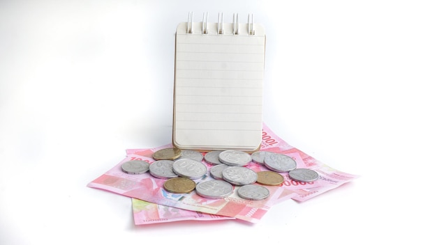 Notebook pen and Indonesia Money on a white background counting money for possible spending planning financial spending and purchases