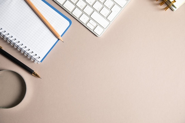 Notebook, pen and keyboard on the table