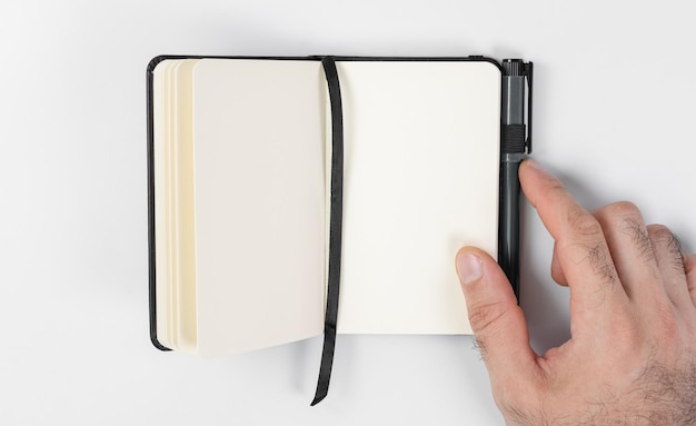 Notebook and pen on white background