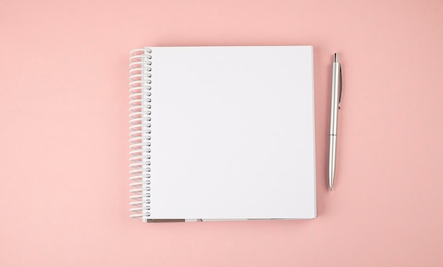 Notebook on the pink background. Copy space