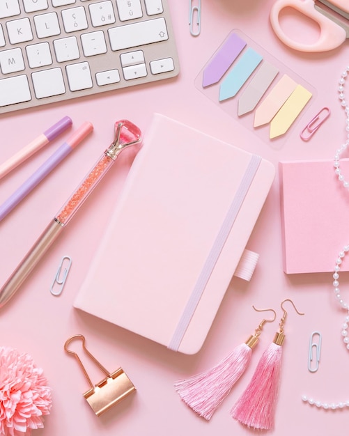 Notebook Pink school girly accessories and keyboard on pastel pink Top view mockup