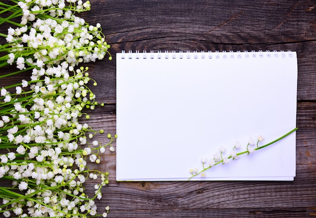 Notebook with clean white sheets on a wooden surface