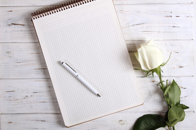 Notebook with pen and rose