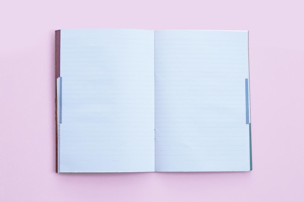 Notebooks on pink background Top view