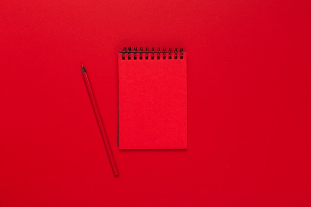 Notepad on a bright colored background, top view